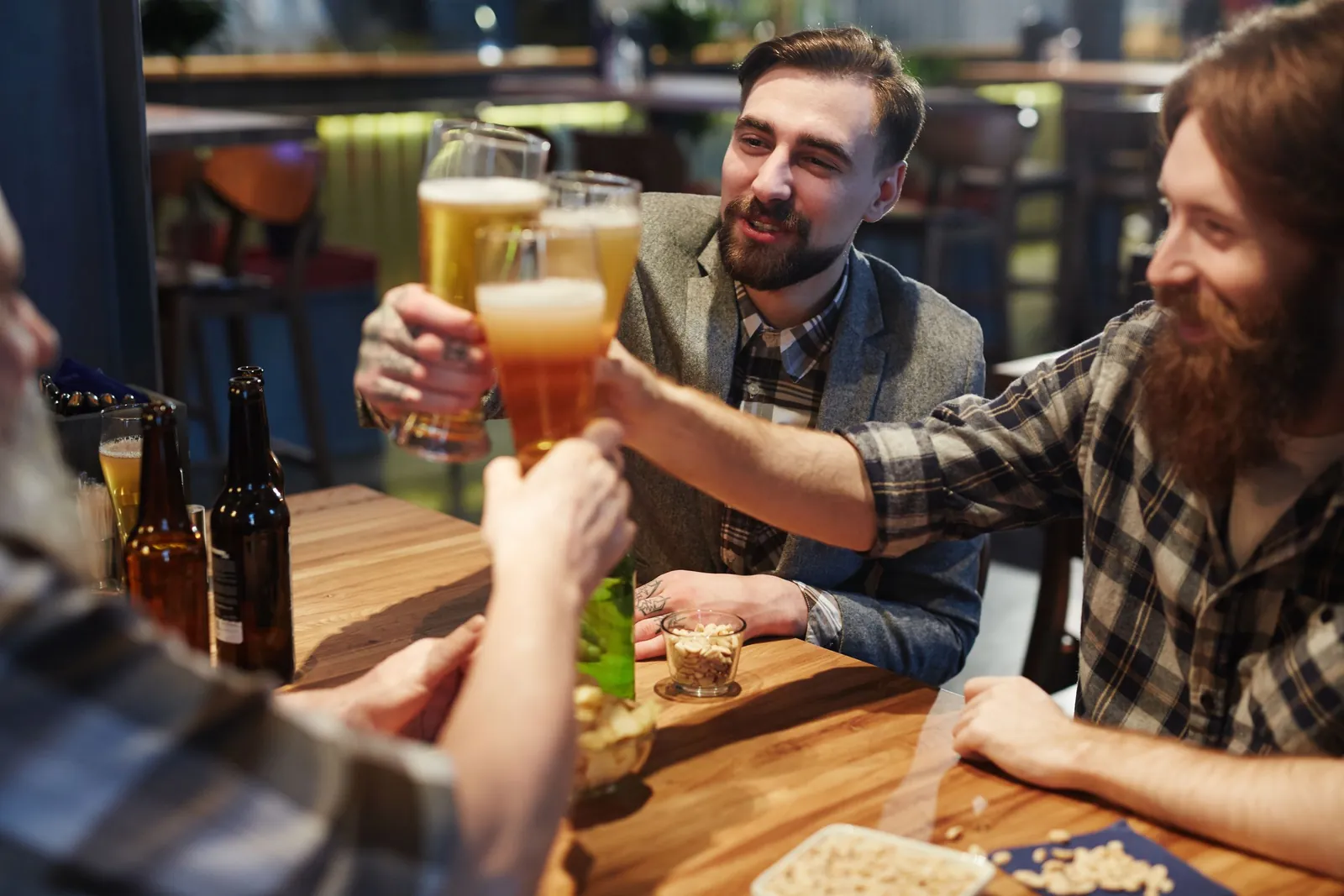 Friends clinking beer glasses at a stag party
